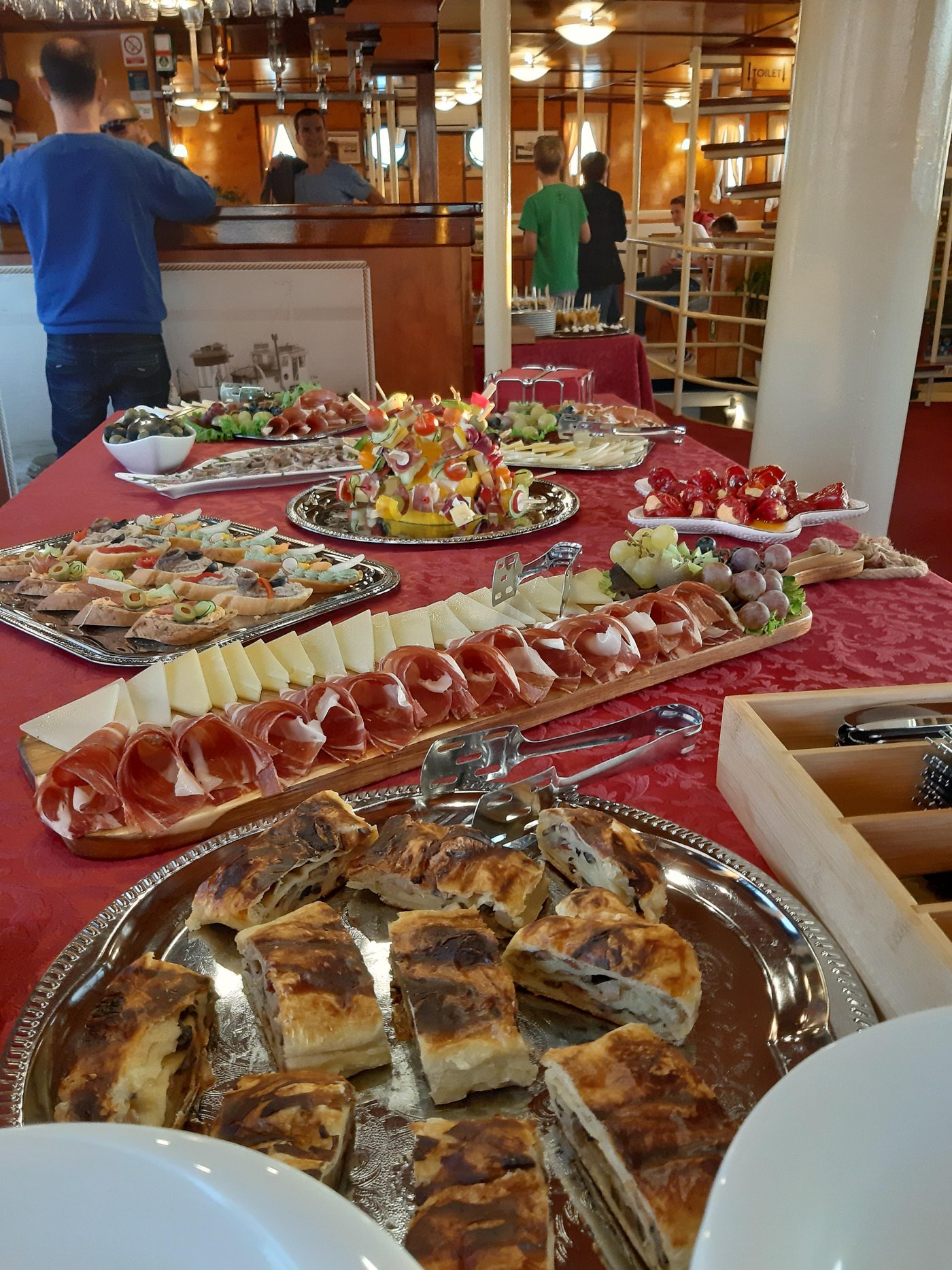 An authentic Dalmatian cold table aboard Polaris with sliced prosciutto, local cheeses, canapés, olives and savory pastries