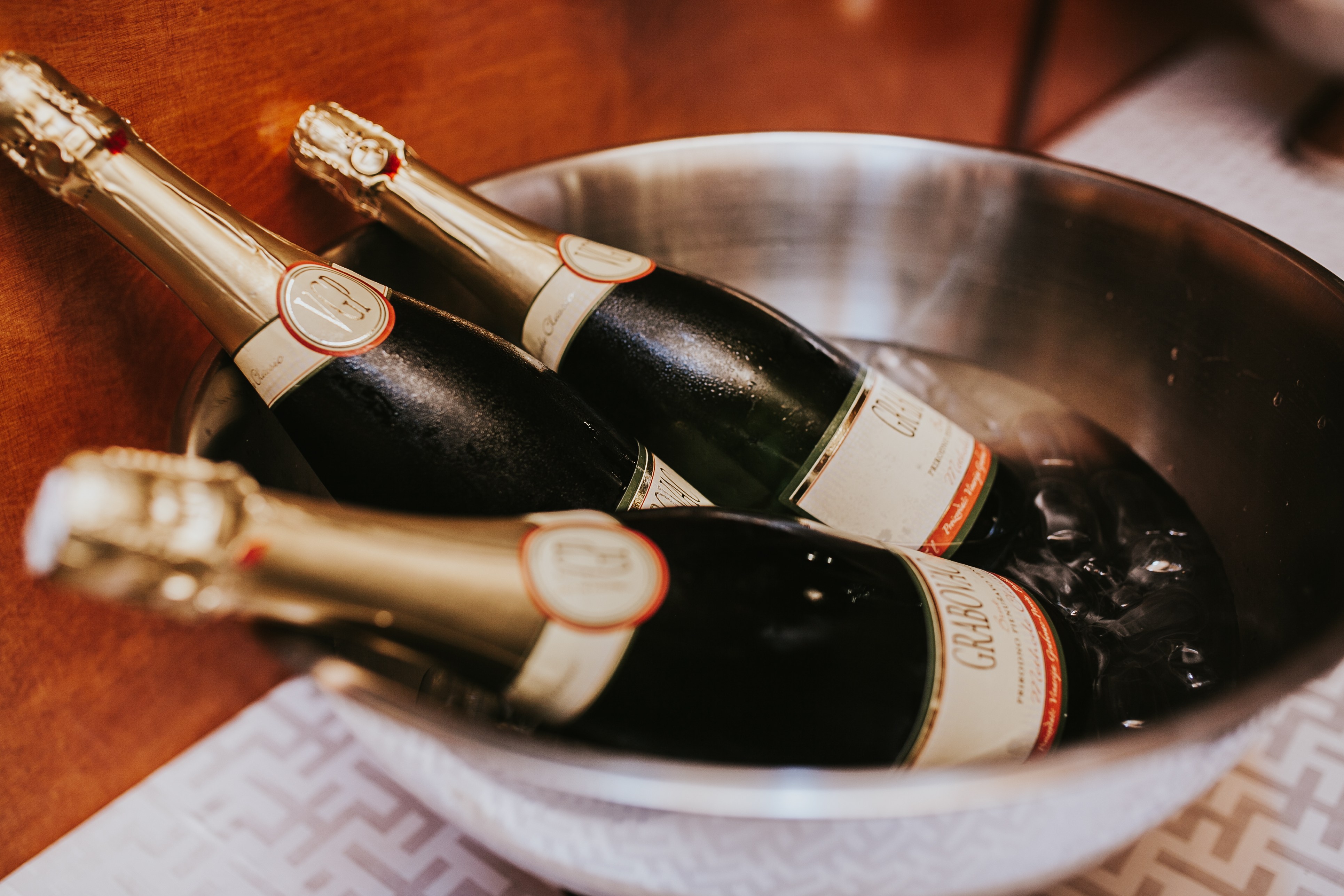 Bottles of sparkling wine chilling in a stainless ice bucket aboard the yacht