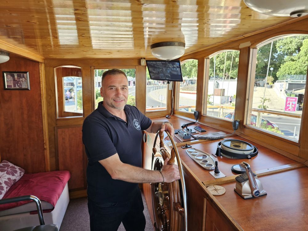 Marin Novaković, captain of Polaris and owner of the company, at the ship's wheel in the wheelhouse