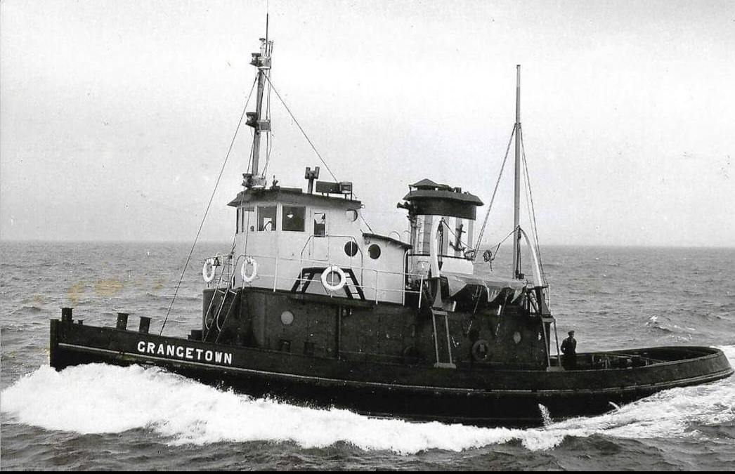 The tug Grangetown steaming through open sea with a bow wave, before she was renamed Polaris