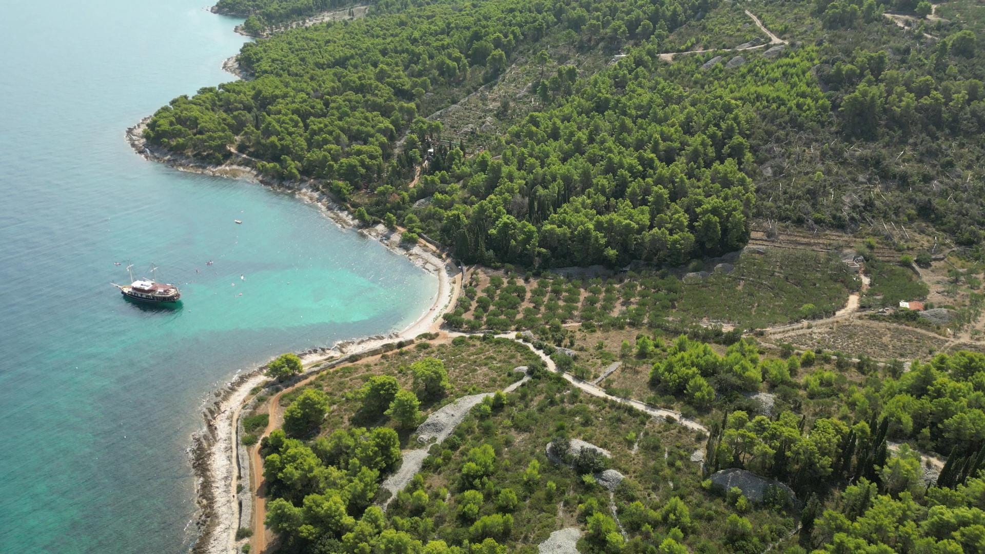 Drone view of the Brač coastline with Polaris anchored in a cove