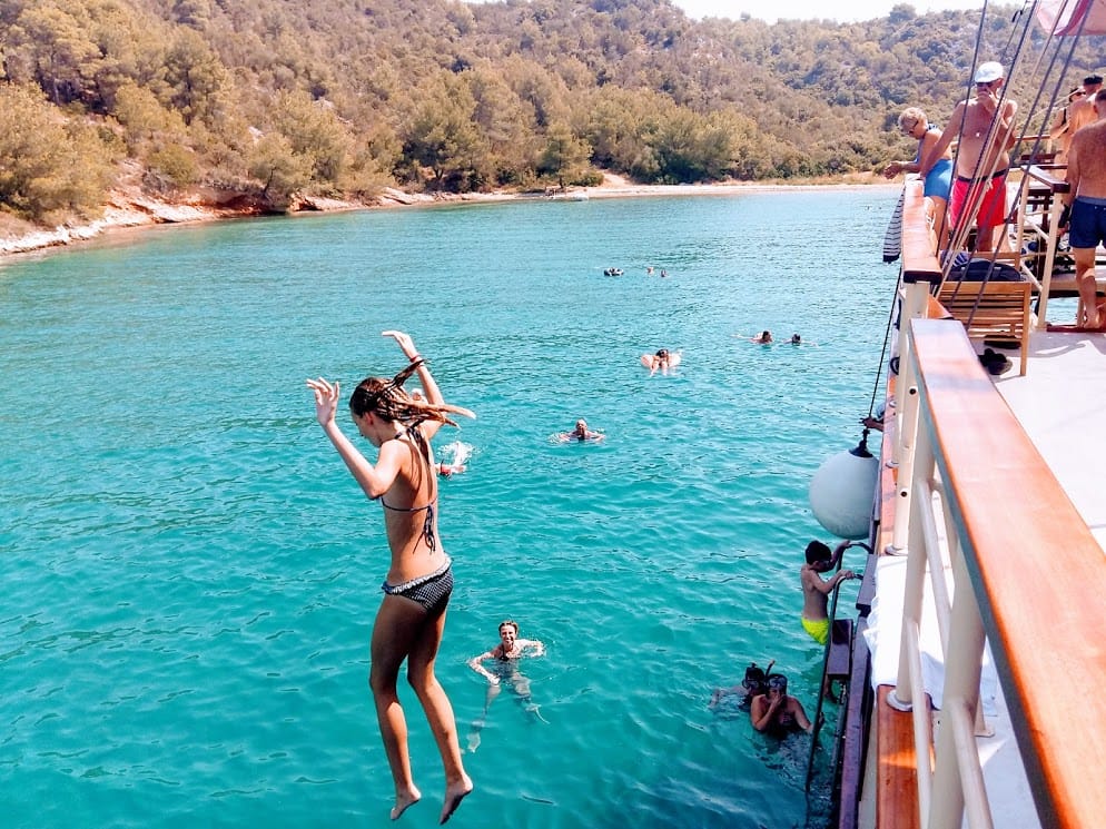 Guest jumping from the boat into the clear Adriatic sea